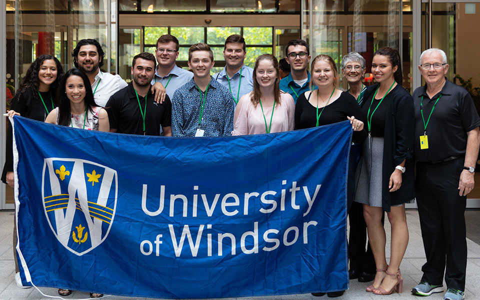 International relations and development studies group photo of people holding univeristy of windsor flag